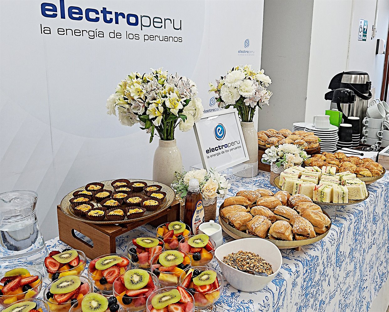 Coffee break para empresas con frutas, sándwiches, quiches y café servido en un evento corporativo